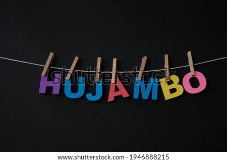 Word Hujambo in black background. Hujambo means hello in Swahili.