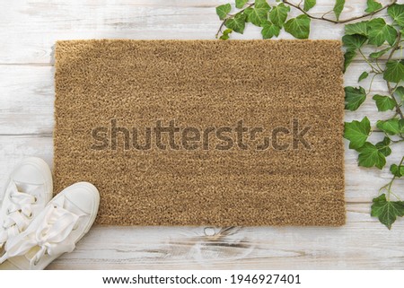 Coir doormat mockup Green plant spring wooden background Royalty-Free Stock Photo #1946927401