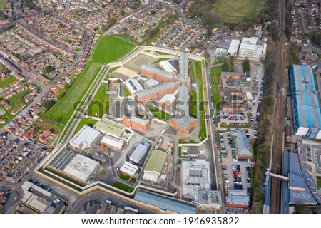 Aerial drone photo of the town centre of Wakefield in West Yorkshire in the UK showing the main building and walls of Her Majesty's Prison, also know as HMP Wakefield taken in the spring time Royalty-Free Stock Photo #1946935822