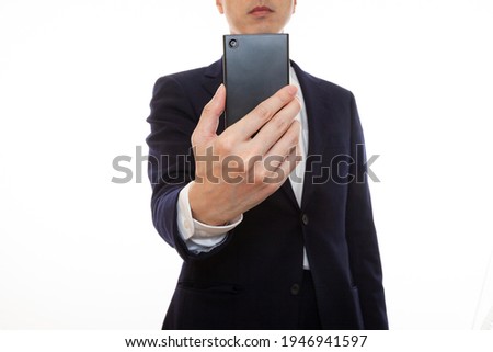 Business person shooting with a smartphone, front