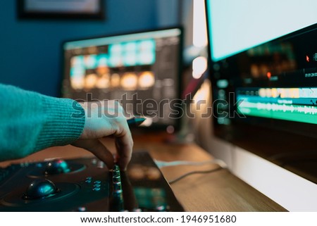 Male Video Editor hand Works with Footage or Video on His Personal Computer, he Works in Creative Office Studio or home. Neon lights