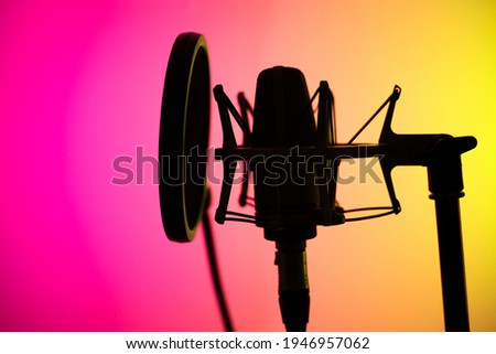 Voiceover studio large diaphragm cardioid microphone in professional voice recording studios. Royalty-Free Stock Photo #1946957062