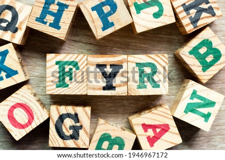 Alphabet letter block in word FYR (abbreviation of for your reference) with another on wood background
