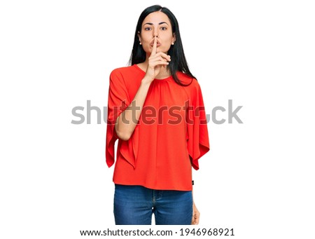 Beautiful young woman wearing casual clothes asking to be quiet with finger on lips. silence and secret concept. 