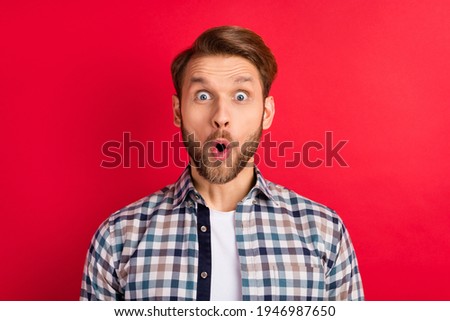Photo of young handsome man amazed shocked surprised news sale excited isolated over red color background