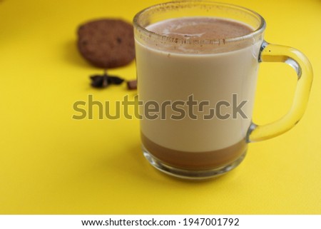 a cup of hot chocolate cocoa on a bright yellow background with room for a copyspace text.