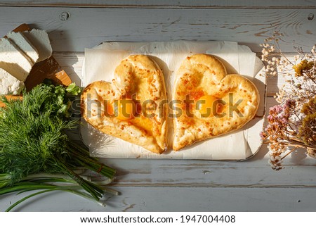 two khachapuri in the shape of a heart. dinner in a Georgian restaurant for two on Valentine's Day