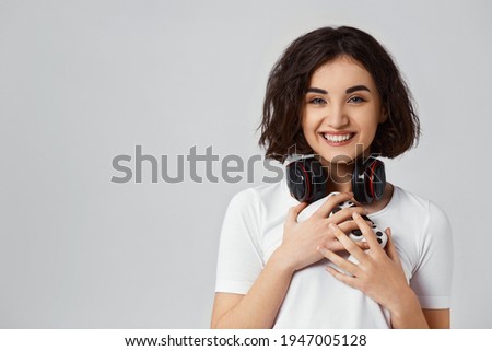 girl playing video games on gray background