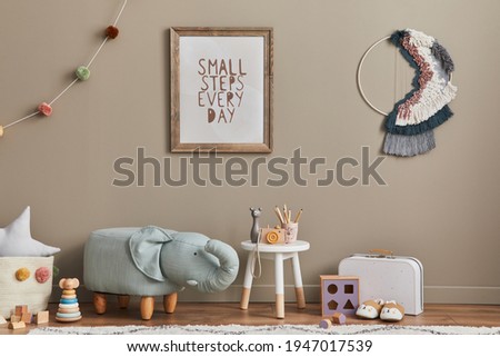 Stylish scandinavian kid room interior with toys, elephant pouf, plush animal toys, furniture, decoration and child accessories. Brown wooden mock up poster frames on the wall. Template