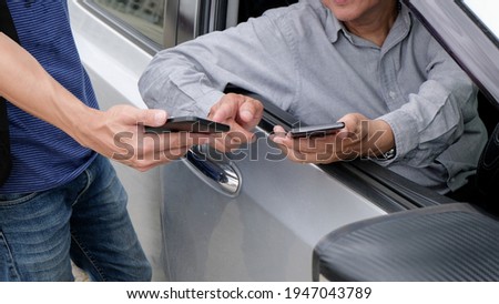 Taxi Transfer Service Driver talking with passenger and holding mobile phone in hand for waiting Taxi