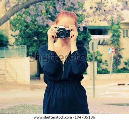 woman with old vintage camera outdoors