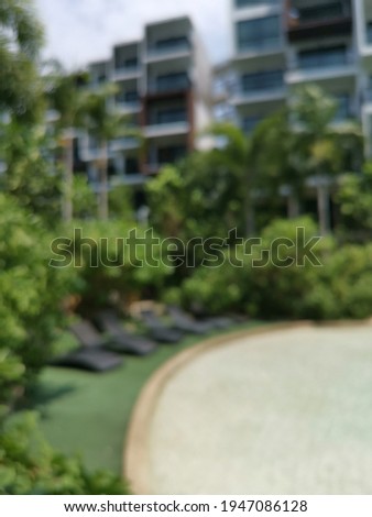 Defocused image of hotel in a city. Blurred background with place for your design
