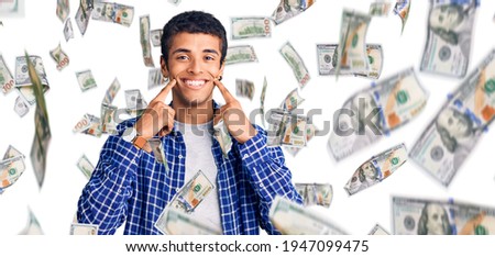 Young african amercian man wearing casual clothes smiling with open mouth, fingers pointing and forcing cheerful smile
