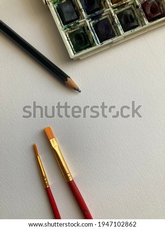 Photo of some art supplies in a paper background