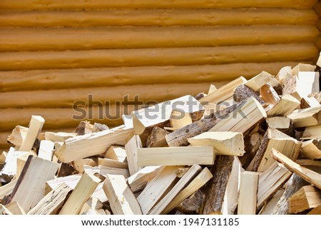 Stacked chopped firewood close-up. Firewood storage close up. Stocks of wooden logs close-up. Chopping wood. Logging in the village. Rustic lifestyle. Woodpile with firewood. Wood texture. Royalty-Free Stock Photo #1947131185