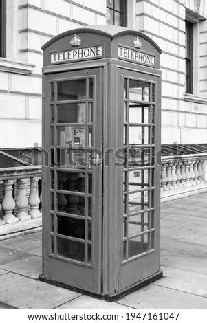 Black and white photo of a traditional phone box in London Royalty-Free Stock Photo #1947161047