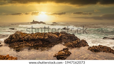Beautiful seascape, ocean views, rocky coast, sunlight, on the horizon. Composition of nature. Sunset scenery background. Cloudy sky. Water Reflection. California Seashore.