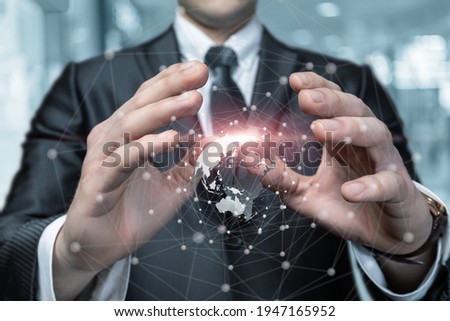 Business man protects the global business network with a protective gesture.