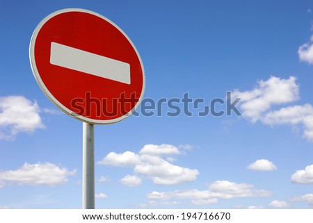 Roadside red stop sign on a cloudy background
