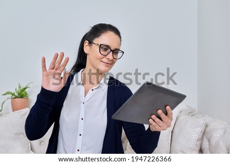 Business woman talking online using video call on digital tablet