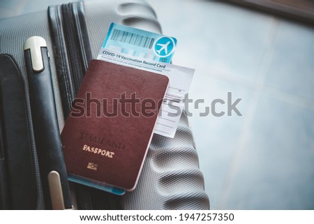 Passports and suitcases to prepare for the trip and coronavirus vaccination card, map for travel with luggage for the trip. Covid-19 around the world