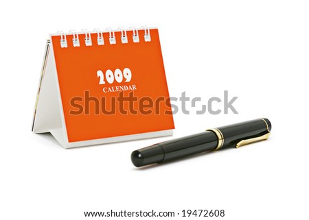Mini desk top calender and fountain pen isolated on white background