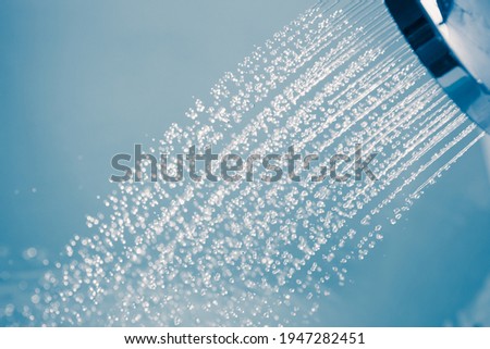 douche water drops, blue background Royalty-Free Stock Photo #1947282451