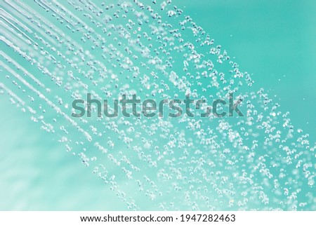 douche water drops, emerald background Royalty-Free Stock Photo #1947282463
