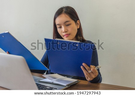 Young business supervisor reading the sales reports