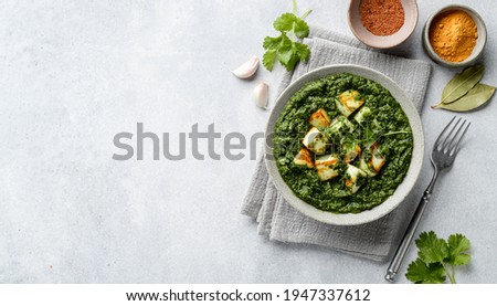 Palak Paneer on concrete background, top view, copy space Royalty-Free Stock Photo #1947337612