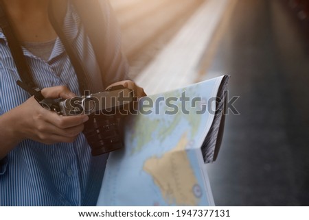 Image of Young freelance with camera on hands at train station before travel. work and travel concept.