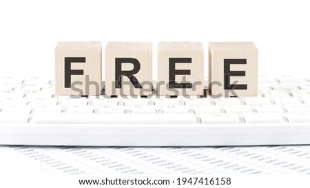 FREE -word wooden block on the keyboard background witn chart