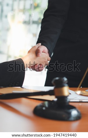 Businessman shaking hands to seal a deal with his partner
lawyers or attorneys discussing a contract agreement.Legal law, advice, and justice concept. Royalty-Free Stock Photo #1947419440