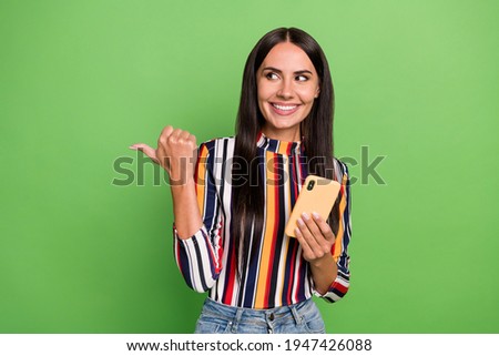 Portrait of attractive trendy cheerful girl using device browsing 5g showing copy space ad isolated over green pastel color background