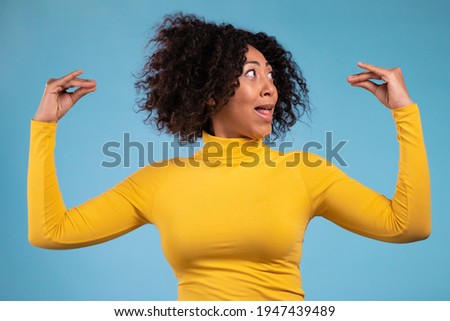 Pretty african woman showing bla-bla-bla gesture with hands isolated on blue background. Empty promises, blah concept. Lier. Royalty-Free Stock Photo #1947439489
