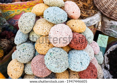 multicolored pumice stone in wicker baskets on wooden tables