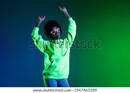 Photo of funny pretty dark skin lady raise hands dancing have good mood isolated on vivid color background
