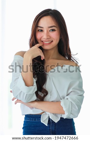 Portrait of young and cute Asian girl pose to camera with self confident and friendly happy face.