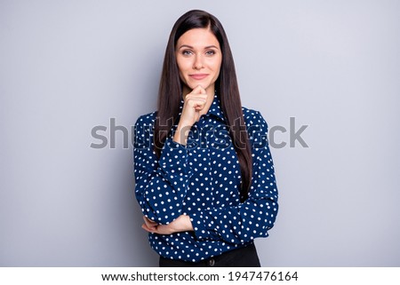 Photo of optimistic brunette girl fist chin wear blue blouse isolated on grey color background