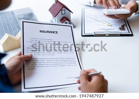 Real estate agent explains documents for home insurance to customers who come to buy a house, buy or sell real estate to enter into a contract for sale and deliver a model house,contract signing ideas