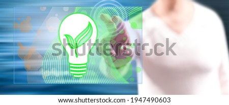 Woman touching a green energy concept on a touch screen with her fingers