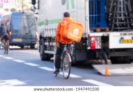 Blurred image of food delivery by bycicle in downtown in Europe.