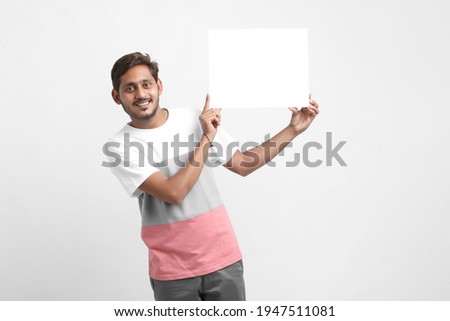 Indian male college student showing blank signboard