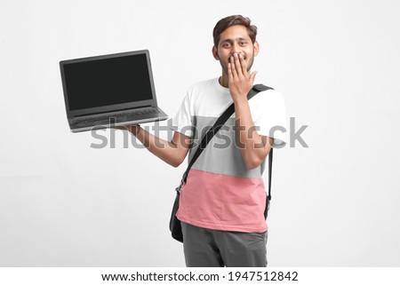 Indian college student showing laptop screen on white background.