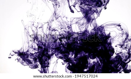 Take a picture of ink into the water on white background.