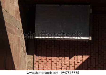 
the photo shows a shadow on a brick wall
