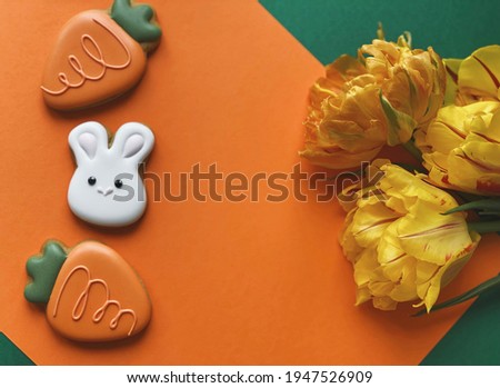 Cute white Easter bunny cookie with orange tulips 