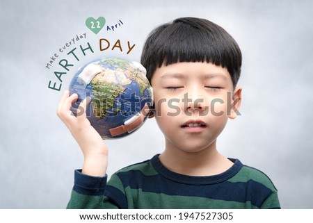 Earth Day campaign, ready to use poster, banner for global warming awareness. April 22. A little asian boy hold a broken globe with care. World pollution, Pandemic, Environmental crisis, Sustainable. Royalty-Free Stock Photo #1947527305