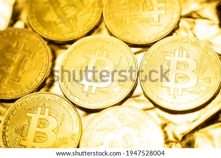 Golden bitcoin Coins on a golden background. Trading on the cryptocurrency exchange. Cryptocurrency Stock Market Concept. Virtual money concept. Mining or blockchain technology. Business concept.