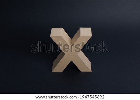 corporate lettering on cardboard paper on black background